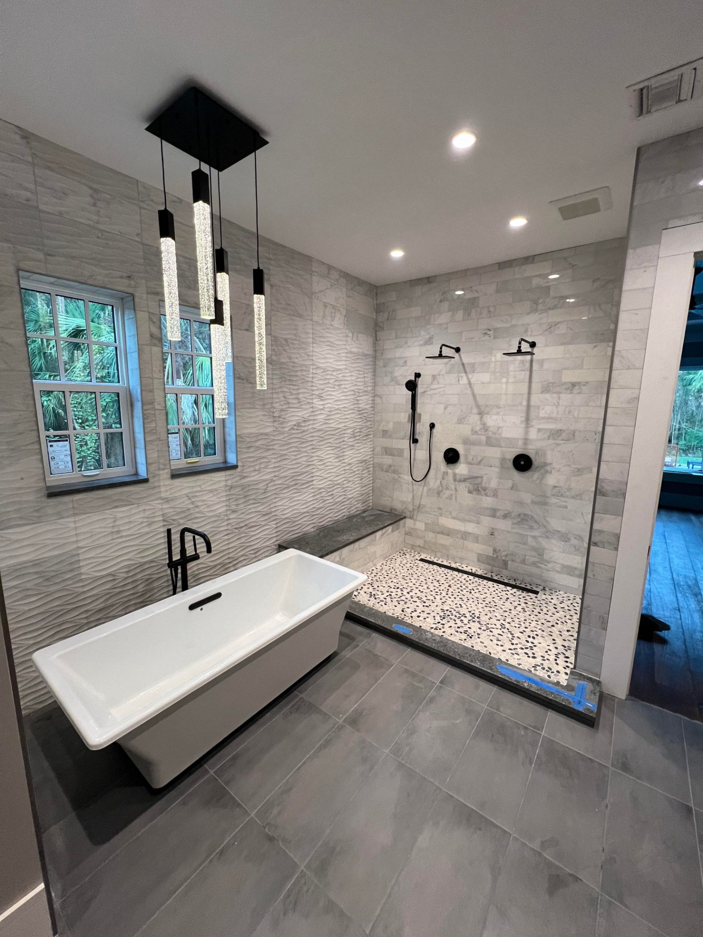 White tiled bathroom with freestanding bath